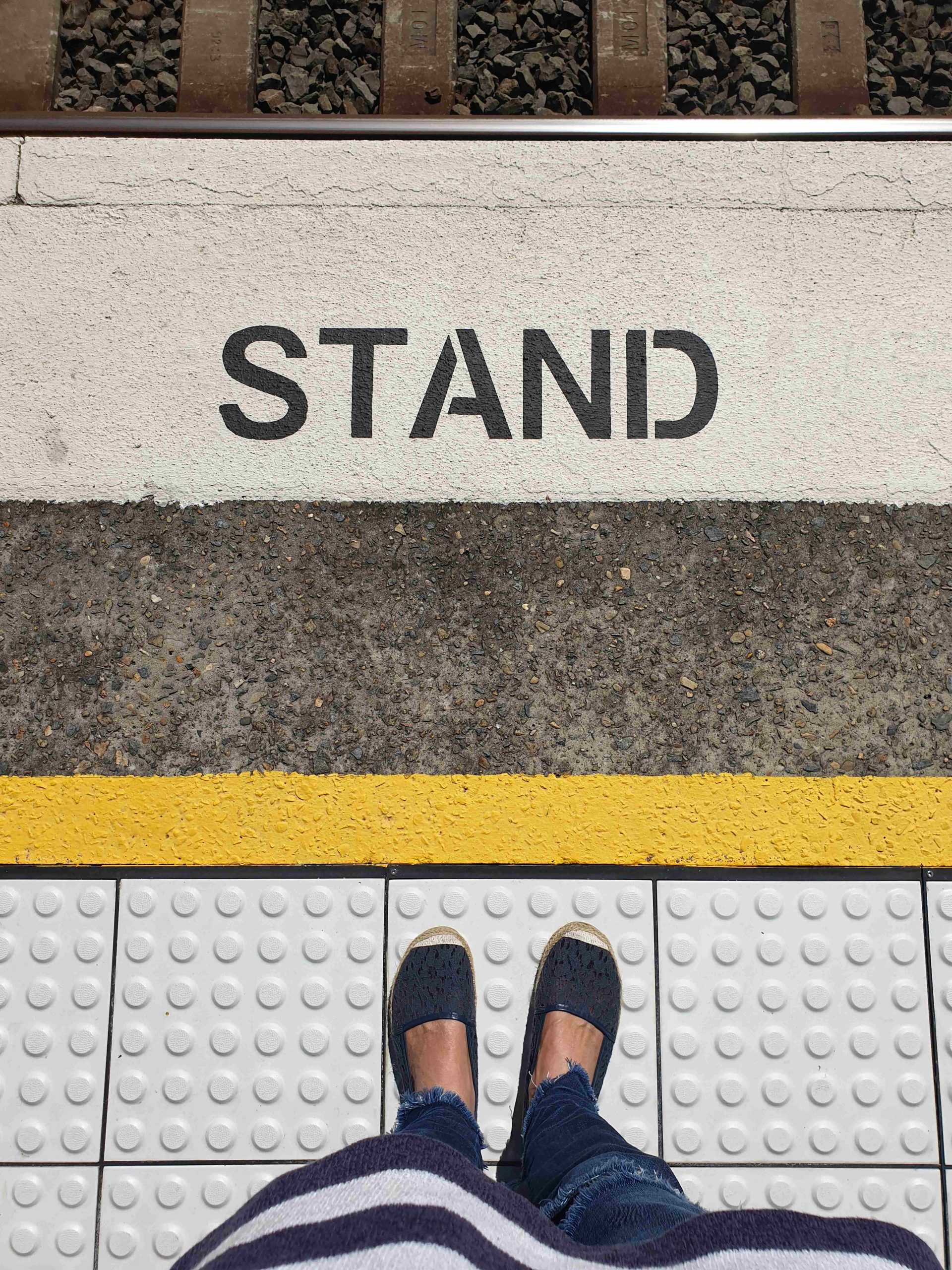 low-section-woman-standing-railroad-station-platform