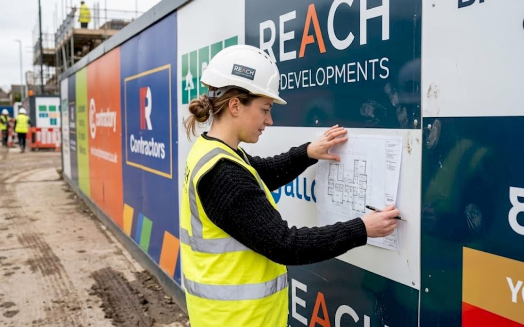 Project manager reviewing branded site signage