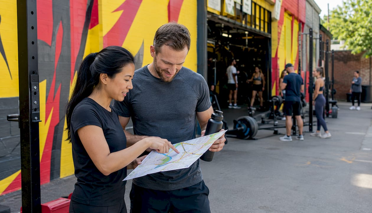 Marketing team reviewing gym foot traffic data outside